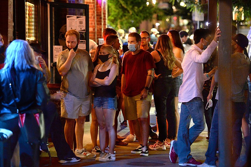 A line forms Aug. 28 outside a bar as staff monitors the number of people inside on Dickson Street in Fayetteville. Visit nwaonline.com/200906Daily/ for today's photo gallery.
(NWA Democrat-Gazette/Andy Shupe)