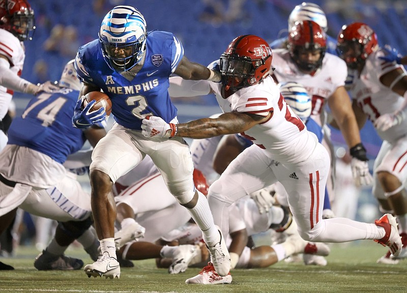 T.J. Carter, a defensive back for the Memphis Tigers, tries to shake off one of the Arkansas State Red Wolves on Saturday, Sept. 5, 2020, at the Liberty Bowl in Memphis. story.lead_photo.caption