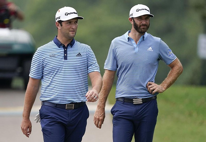 Jon Rahm (left) and Dustin Johnson matched birdies on five holes Friday and ended the first round of the Tour Championship tied for the lead at East Lake Golf Club in Atlanta. Both were at 13-under par based on their starting positions in the FedEx Cup finale.
(AP/John Bazemore)
