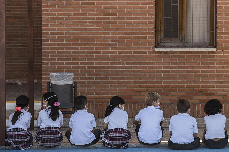 Pupils wait to wash their hands Friday on the first day of classes at SEK-El Castillo International School in Villafranca del Castillo, on the outskirts of Madrid, Spain.
(AP/Bernat Armangue)