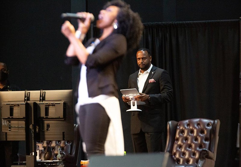 Pastor Jesse Curney III of the New Mercies Christian Church in Lilburn, Ga., watches Praise and Worship singer April Thompson perform during the Aug. 2 church service.
(Steve Schaefer for the Atlanta Journal-Constitution)