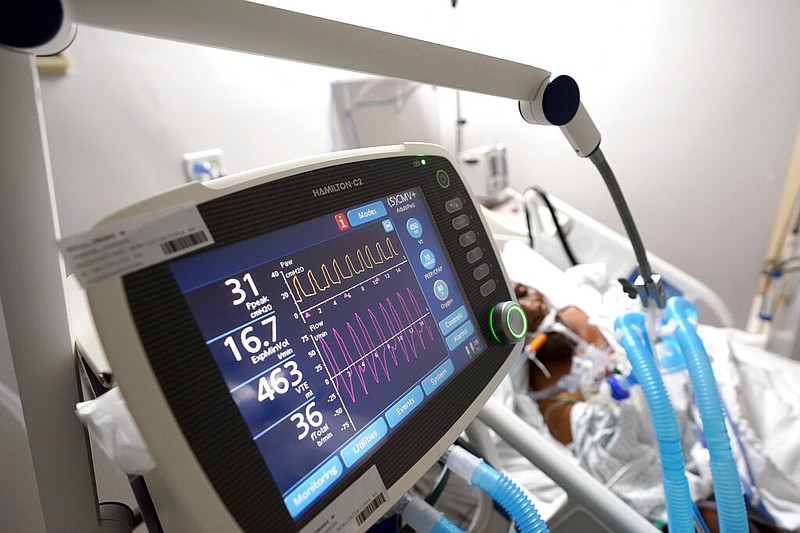 A ventilator helps a covid-19 patient breathe inside the Coronavirus Unit at Houston's United Memorial Medical Center in this July 6, 2020, file photo.