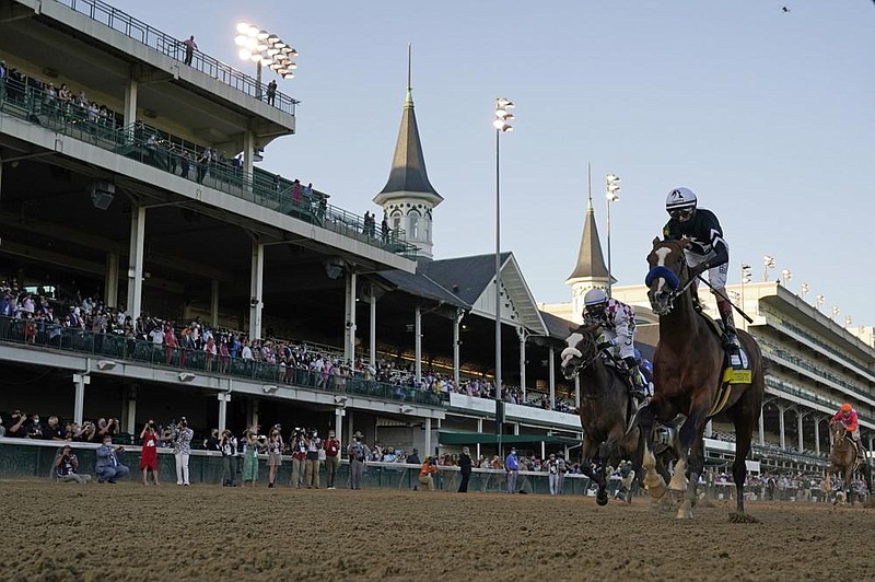 Authentic and jockey John Velazquez (right) cross the finish line ahead of Tiz the Law and jockey Manny Franco on Saturday to win the Kentucky Derby at Churchill Downs in Louisville, Ky. It was the third Derby victory for Velazquez and the record-tying sixth for trainer Bob Baffert.
(AP/Jeff Roberson) story.lead_photo.caption