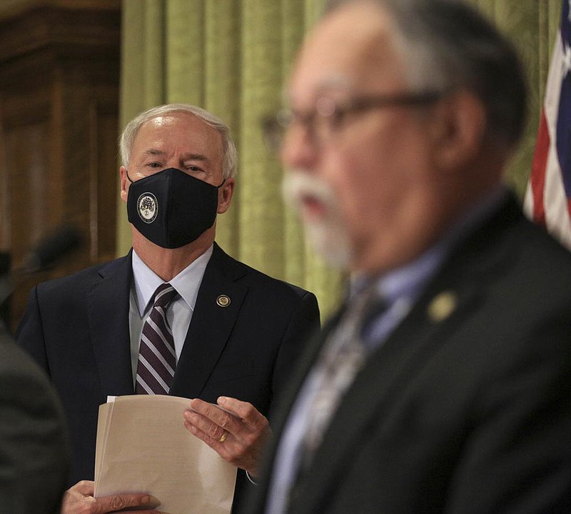 Gov. Asa Hutchinson listens Thursday Sept. 3 in Little Rock as Health Secretary Dr. Jose Romero speaks during a COVID-19 briefing at the state Capitol. (Arkansas Democrat-Gazette/Staton Breidenthal) story.lead_photo.caption