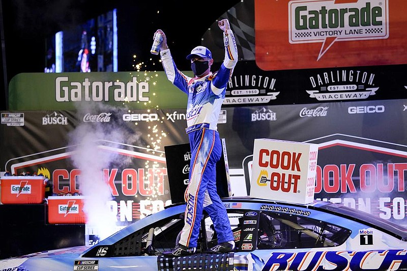 Kevin Harvick celebrates after winning Sunday’s NASCAR Cup Series race in Darlington, S.C. It was his series-best eighth victory of the season. (AP/Chris Carlson) 