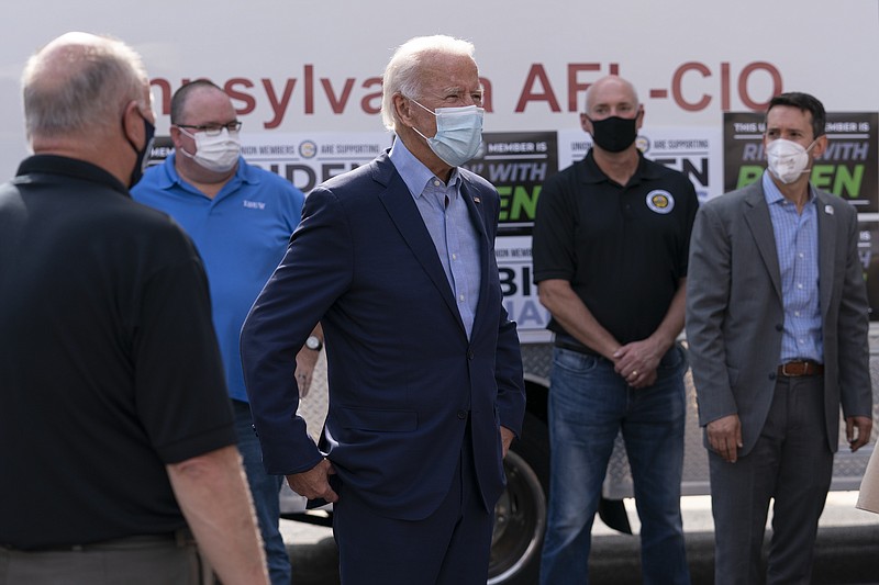 Democratic presidential candidate former Vice President Joe Biden talks with union leaders after taking photographs outside the AFL-CIO headquarters in Harrisburg, Pa., Monday, Sept. 7, 2020. (AP Photo/Carolyn Kaster)