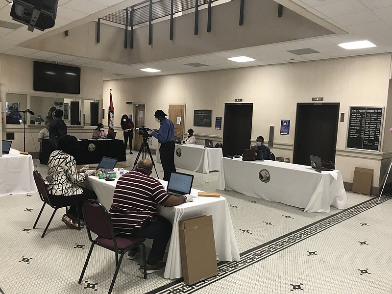 FILE - Members of the Jefferson County Quorum Court and staff maintain a safe social distance of at least six feet between other people during a meeting in April 2020 in Pine Bluff.