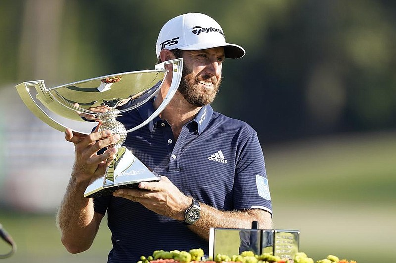 Dustin Johnson celebrates on the 18th green after finishing with a 2-under 68 to win the Tour Championship and take the FedEx Cup on Monday at East Lake Golf Club in Atlanta. (AP/John Bazemore) 