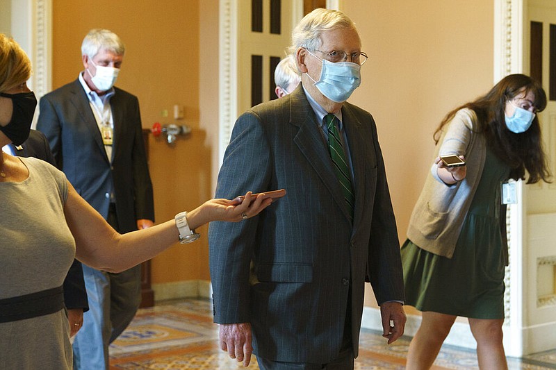 Senate Majority Leader Mitch McConnell of Ky., center, walks to his office from the Senate floor, Tuesday, Sept. 8, 2020, on Capitol Hill in Washington. 