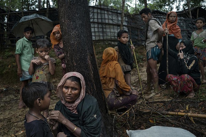 Rohingya refugees who fled Burma rest near a refugee camp in Bangladesh in August 2017 after crossing the border illegally. (The New York Times/Adam Dean) 