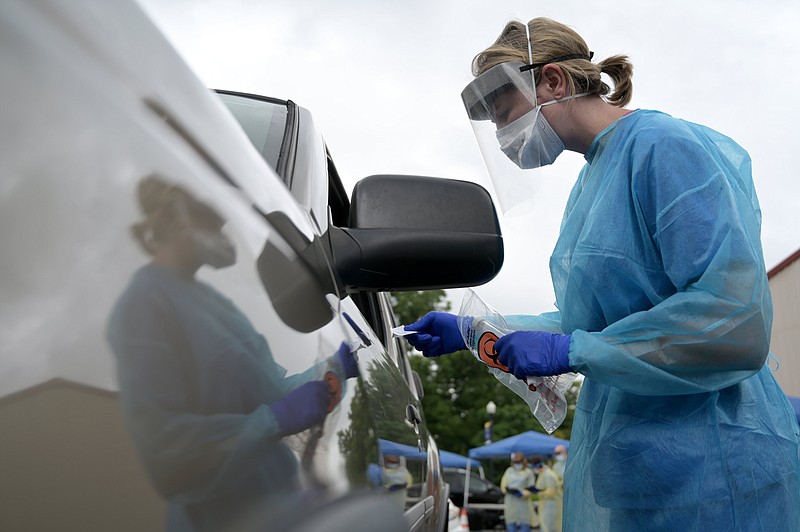 FILE -- Hannah Rahn, RN, delivers a test at a community drive-thru testing clinic for COVID-19 at Shorter College on Tuesday, June 30, 2020.
(Arkansas Democrat-Gazette / Stephen Swofford)