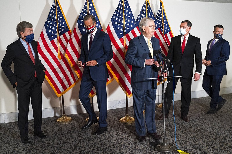 Senate Majority Leader Mitch McConnell of Ky., center, approaches the microphones accompanied by, from left, Sen. Roy Blunt, R-Mo., Sen. John Thune, R-S.D., Sen. John Barrasso, R-Wyo., and Sen. Todd Young, R-Ind., at the start of a news conference, Wednesday, Sept. 9, 2020, on Capitol Hill in Washington. (AP Photo/Jacquelyn Martin)

