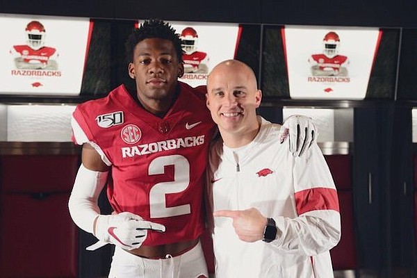 Arkansas receiver commit Jaedon Wilson and Razorbacks receivers coach Justin Stepp.