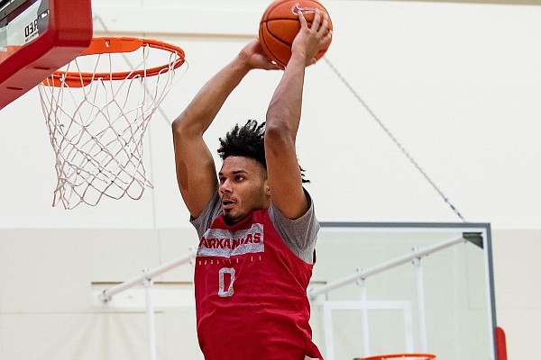 Arkansas forward Justin Smith dunks the ball during a preseason practice in the Basketball Performance Center.