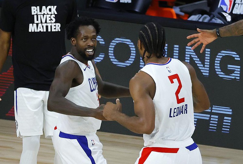 Former Arkansas Razorback Patrick Beverley (left) celebrates with teammate Kawhi Leonard after the Los Angeles Clippers beat the New Orleans Pelicans in an NBA game last month. Earlier this season, Leonard had high praise for Beverley. “Pat’s energy, his will to want to win every game, his toughness — I mean, I’ll take that every day,” Leonard said.
(AP/Kevin C. Cox)
