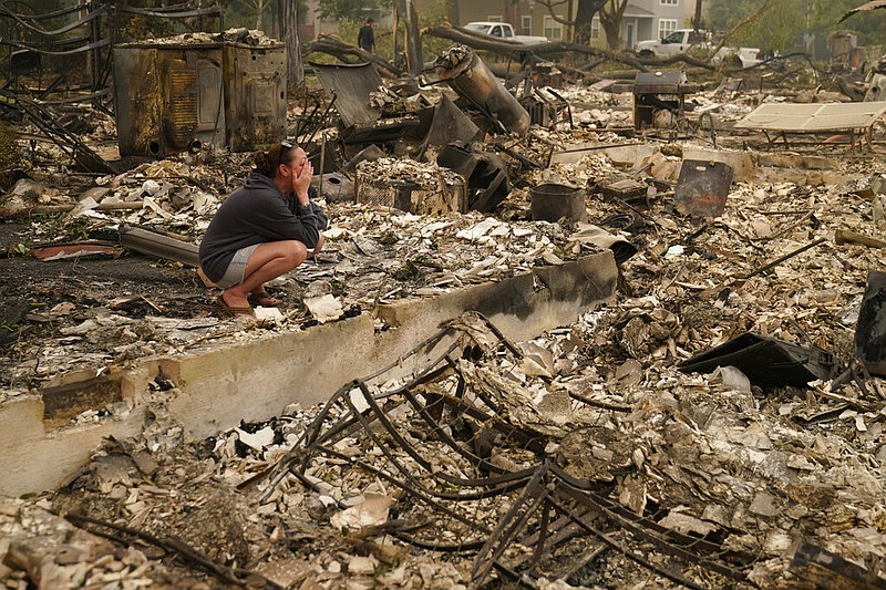 Desiree Pierce cries as she visits her home destroyed by the Almeda Fire, Friday, Sept. 11, 2020, in Talent, Ore. "I just needed to see it, to get some closure," said Pierce. (AP Photo/John Locher)

