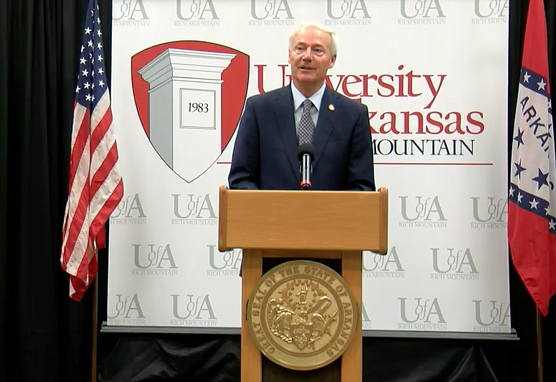 Arkansas Gov. Asa Hutchinson speaks to reporters at the University of Arkansas Community College at Rich Mountain in Mena on Friday in this still of video provided by the governor's office. 