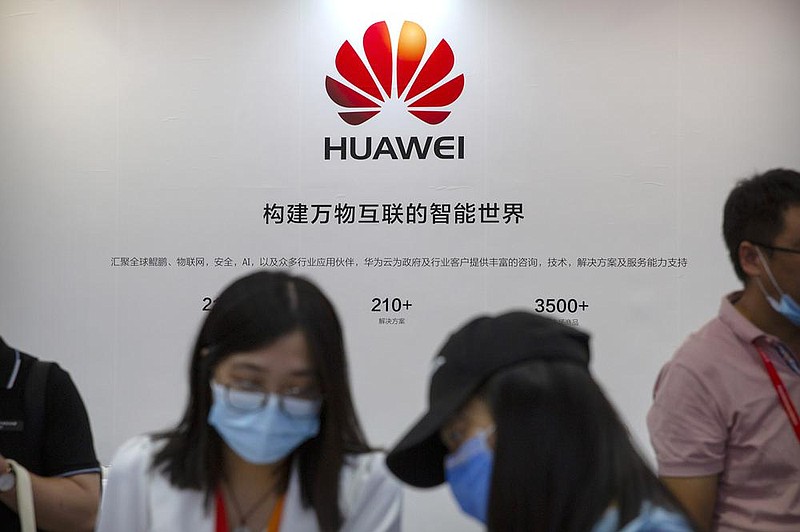 People visit a HuaweiTechnologies booth Saturday at  the China International Fair for Trade in Services in Beijing. A Huawei executive says the company has gained 51% in the Chinese smartphone industry in spite of U.S. sanctions. 
(AP/Mark Schiefelbein)