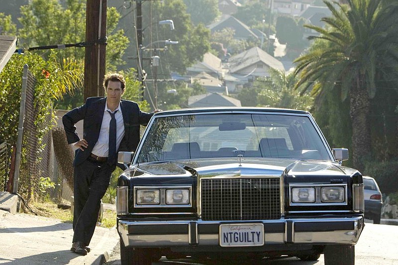 Mick Haller (Matthew McConaughey) poses alongside his mobile office in “The Lincoln Lawyer” (2011).