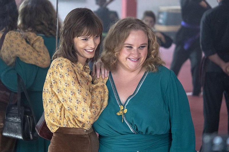 Helen Reddy (Tilda Cobham-Hervey) and Lilian Roxon (Danielle Macdonald) — Aussie expatriates in New York — enjoy a quiet moment before Reddy becomes a ’70s feminist icon in “I Am Woman.”