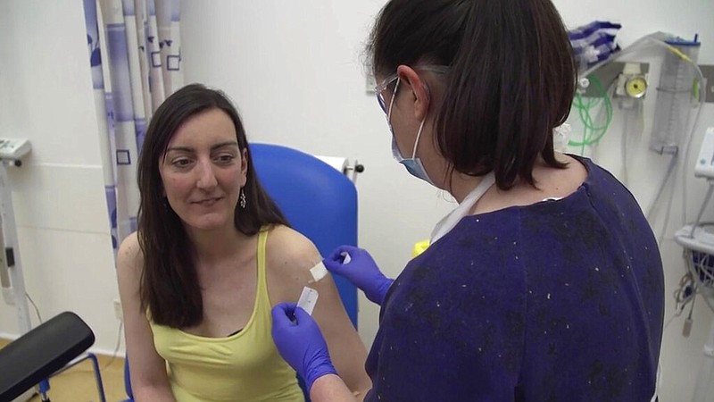 Microbiologist Elisa Granato (left) is injected with a potential coronavirus vaccine at Oxford University, England, in this April 23, 2020, screen grab from video issued by the university. Granato was part of the first human trials in the U.K. for a vaccine.