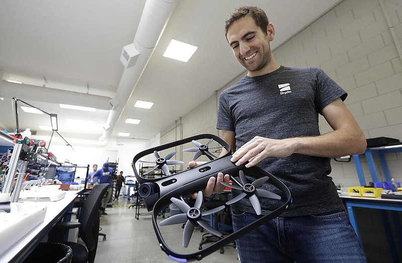Adam Bry, founder of Skydio, holds the R1 flying camera drone during an interview in Redwood City, Calif. U.S. political and security concerns about the world’s dominant consumer drone-maker, China-based DJI, have opened the door for Skydio to pitch its drones for government and business customers.
(AP/Jeff Chiu)