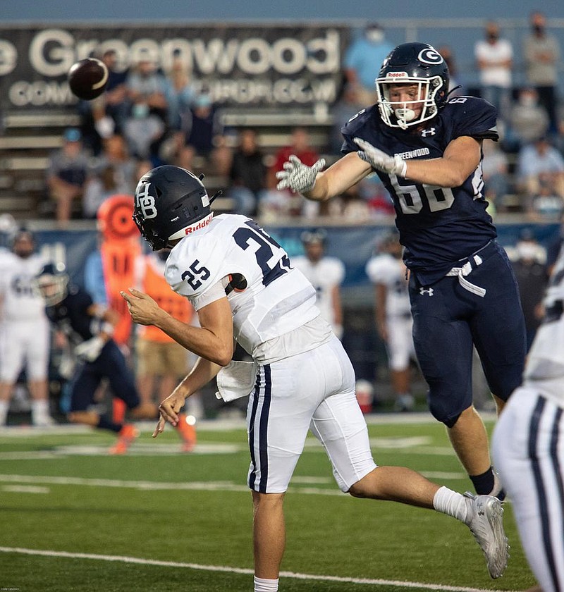 Greenwood’s Beau Asher pressures Springdale Har-Ber quarterback Giovanni Caviasca in the first half Friday in Greenwood. The Bulldogs won 33-0.
(Special to the NWA Democrat-Gazette/Corey S. Krasko)