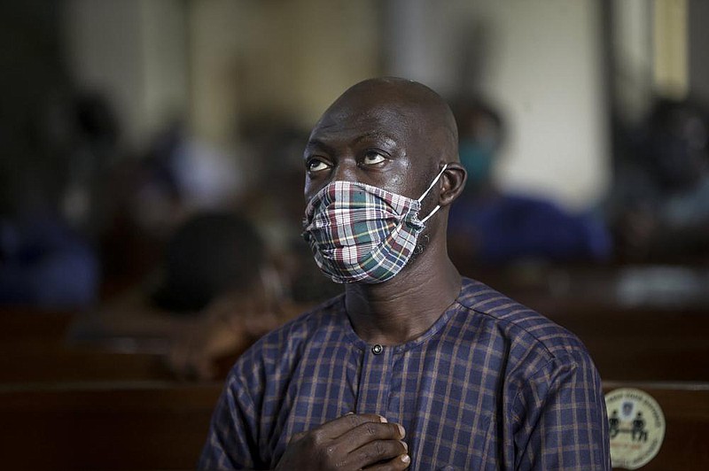 A churchgoer wears a face mask to curb the spread of the coronavirus during a Sunday Mass at Holy Cross Cathedral in Lagos, Nigeria, Aug. 30. The coronavirus pandemic is testing the patience of some religious leaders across Africa who worry they will lose followers, and funding, as restrictions on gatherings continue.
(AP/Sunday Alamba)