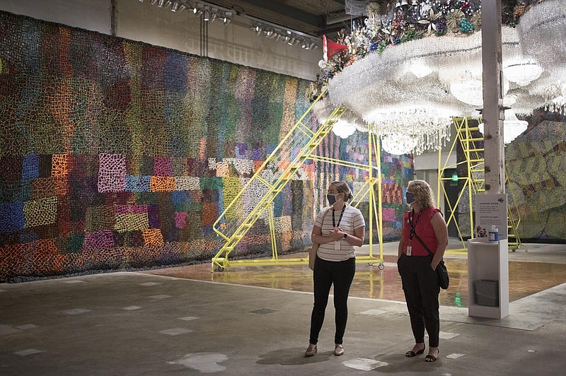 Jessi Mueller (left) and Robin Groesbeck view “Beaded Cliff Wall,” an exhibit piece that is part of “Nick Cave: Until” at the Momentary in Bentonville. The Momentary is presenting the new exhibit, organized by MASS MoCA, through Jan. 3.
(NWA Democrat-Gazette/Charlie Kaijo)