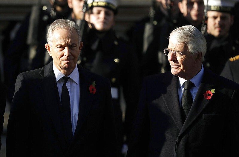 Former British Prime Ministers Tony Blair (left) and John Major attend the Remembrance Sunday ceremony at the Cenotaph in Whitehall in London in this Sunday, Nov. 10, 2019 file photo, Remembrance Sunday is held each year in honor of those who fought in past military conflicts. Blair and Major on Sunday, Sept. 13, 2020, joined forces to urge lawmakers to reject government plans to override the Brexit deal with the European Union.