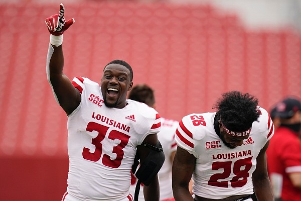 Louisiana-Lafayette linebacker Tyler Guidry (33) and teammate Ja'len Johnson (28) celebrate as they run off the field after an NCAA college football game against Iowa State, Saturday, Sept. 12, 2020, in Ames, Iowa. Louisiana-Lafayette won 31-14. (AP Photo/Charlie Neibergall)