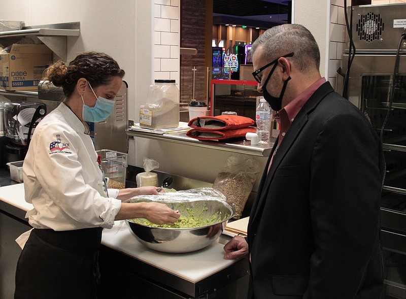 As Saracen Casino Resort Executive Chef Cynthia East prepares a batch of fresh guacamole, Food and Beverage Service Director Todd Gold looks on. (Pine Bluff Commercial/Dale Ellis)