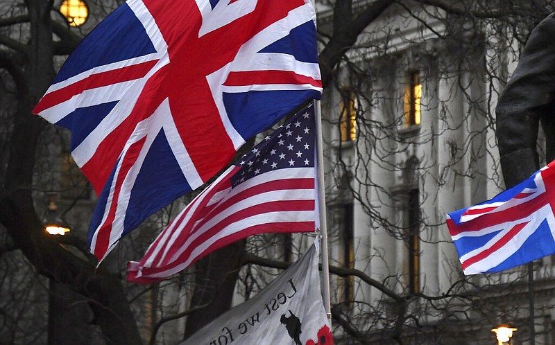 FILE - In this file photo dated Friday, Jan. 31, 2020, Brexit supporters hold British and US flags during a rally in London. The international reputation of the United States has declined further in the wake of its handling of the coronavirus pandemic, according to new research published Tuesday Sept. 15, 2020, from the Pew Research Center. (AP Photo/Alberto Pezzali, FILE)