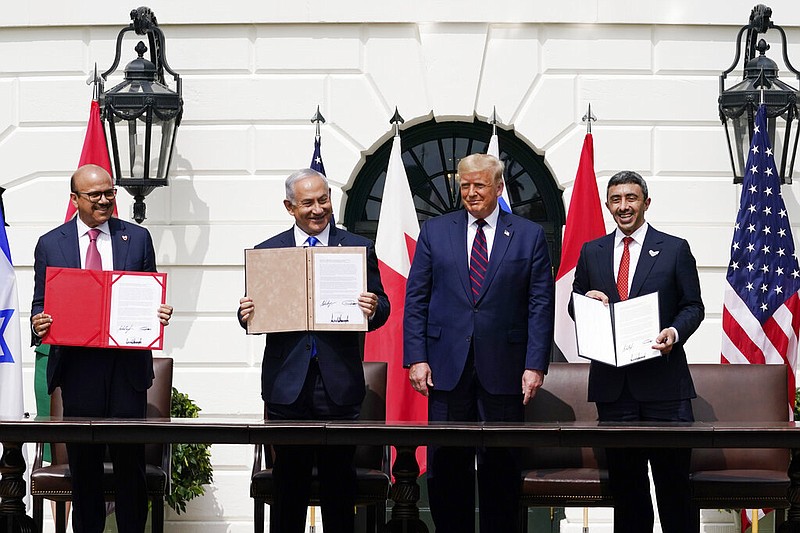 President Donald Trump, center, with from left, Bahrain Foreign Minister Khalid bin Ahmed Al Khalifa, Israeli Prime Minister Benjamin Netanyahu, Trump, and United Arab Emirates Foreign Minister Abdullah bin Zayed al-Nahyan, during the Abraham Accords signing ceremony on the South Lawn of the White House, Tuesday, Sept. 15, 2020, in Washington. (AP Photo/Alex Brandon) story.lead_photo.caption