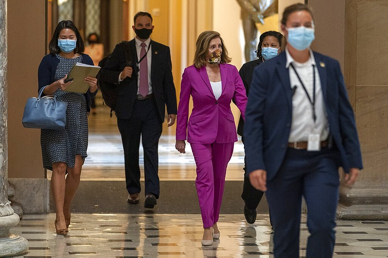 House Speaker Nancy Pelosi of Calif., center, walks to her office, Monday, Sept. 14, 2020, on Capitol Hill in Washington. story.lead_photo.caption