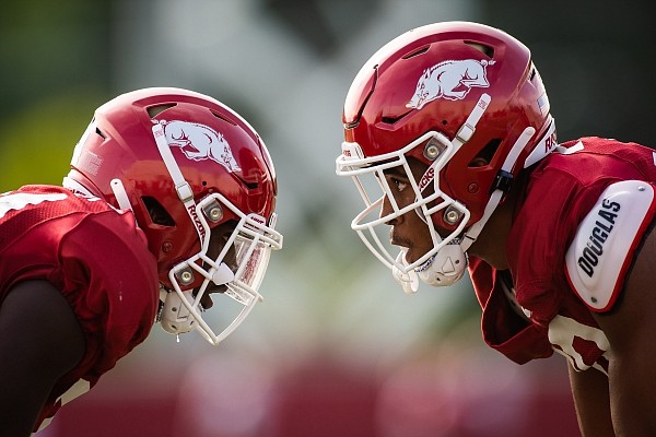 A pair of Arkansas football players ready for a play during a preseason practice on Sept. 14, 2020 in Fayetteville.