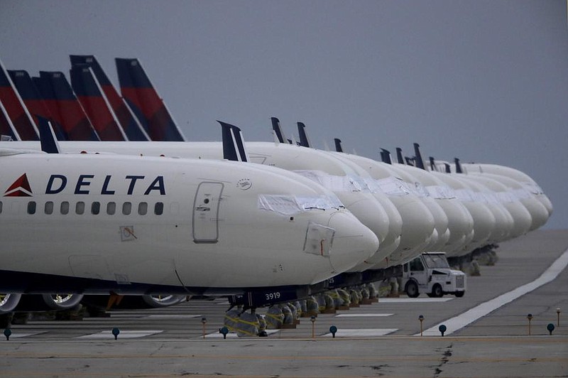 Several dozen mothballed Delta Air Lines jets are parked on a closed runway in May at Kansas City International Airport in Missouri. Delta has announced will use its frequent-flyer program as collateral in a $6.5 billion debt sale. (AP) 