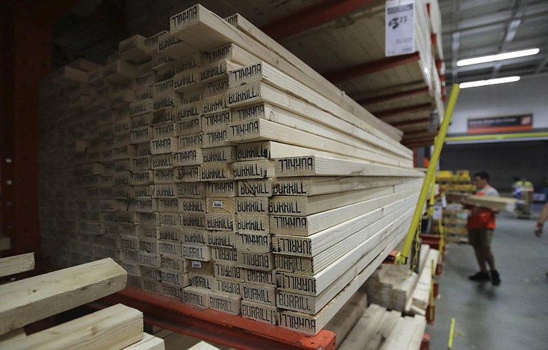 Lumber market called ‘unprecedented’ 
Lumber is stacked at the Home Depot store in Londonderry, N.H., in this 2019 file photo. Last month, futures for lumber reached a record high of $830.90 per 1,000 board feet. (AP) 