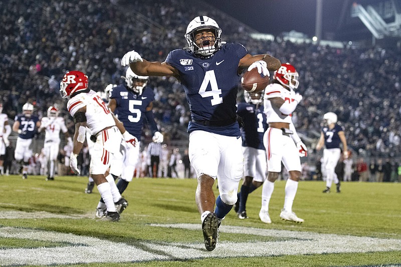 FILE - In this Nov. 30, 2019, file photo, Penn State running back Journey Brown (4) celebrates his third quarter touchdown run against Rutgers during an NCAA college football game in State College, Pa. Big Ten is going to give fall football a shot after all. Less than five weeks after pushing football and other fall sports to spring in the name of player safety during the pandemic, the conference changed course Wednesday, Sept. 16, 2020, and said it plans to begin its season the weekend of Oct. 23-24. (AP Photo/Barry Reeger, File)

