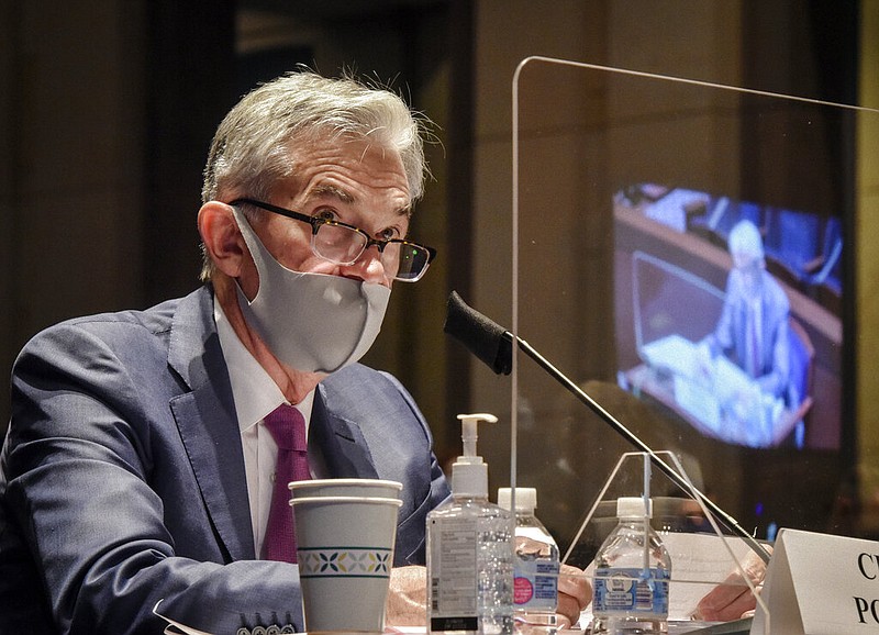 FILE - In this June 30, 2020, file photo Federal Reserve Board Chairman Jerome Powell, reflected in the sneeze guard set up between himself and members of the House Committee on Financial Services, speaks during a hearing on oversight of the Treasury Department and Federal Reserve pandemic response on Capitol Hill in Washington. The Federal Reserve adjusted its inflation target to seek price increases above 2% annually, a move that will likely keep interest rates low for years to come. The Fed on Wednesday, Sept. 16, also left its benchmark short-term rate unchanged at nearly zero, where it has been since the pandemic intensified in March. (Bill O'Leary/The Washington Post via AP, Pool) story.lead_photo.caption