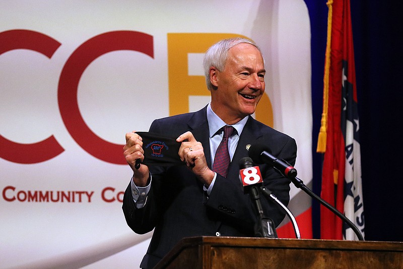 Gov. Asa Hutchinson shows off his mask of the day, which celebrates Independence County’s bicentennial during the COVID-19 briefing on Wednesday, Sept. 16, at the University of Arkansas Community College Batesville. (Arkansas Democrat-Gazette/Thomas Metthe)