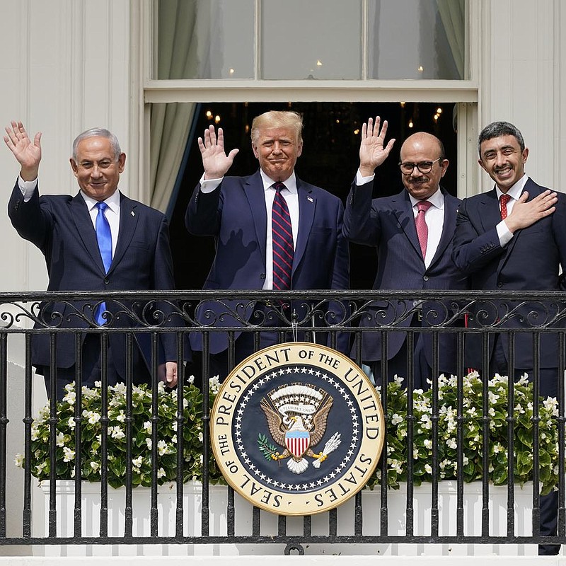 Israeli Prime Minister Benjamin Netanyahu (from left), President Donald Trump, Bahrain Foreign Minister Khalid bin Ahmed Al Khalifa and United Arab Emirates Foreign Minister Abdullah bin Zayed al-Nahyan stand on the balcony overlooking the South Lawn of the White House during the signing ceremony Tuesday. More photos at arkansasonline.com/916president/. 
(AP/Alex Brandon) 
