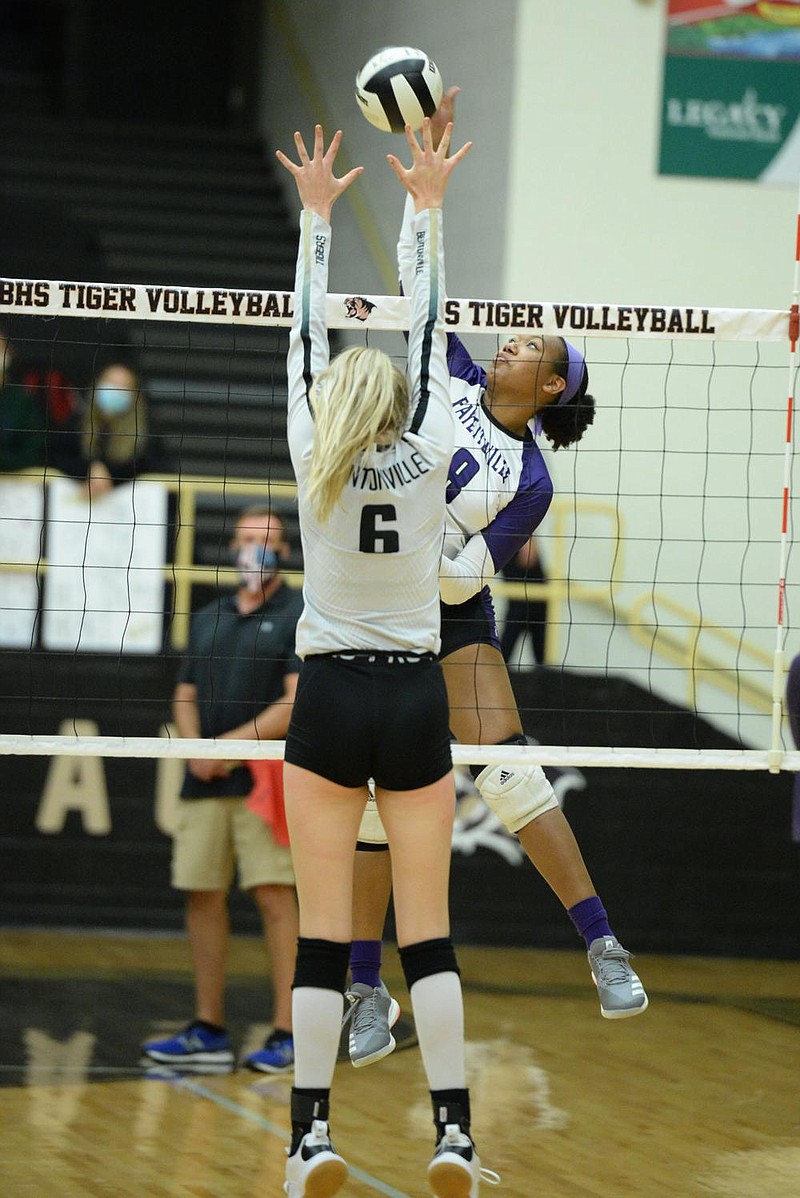 Fayetteville's Rosana Hicks (8) sends the ball over the net Tuesday, Sept. 15, 2020, as Bentonville's Gloria Cranney (6) defends during play in Tiger Arena in Bentonville. Visit nwaonline.com/200916Daily/ for today's photo gallery. 
(NWA Democrat-Gazette/Andy Shupe)