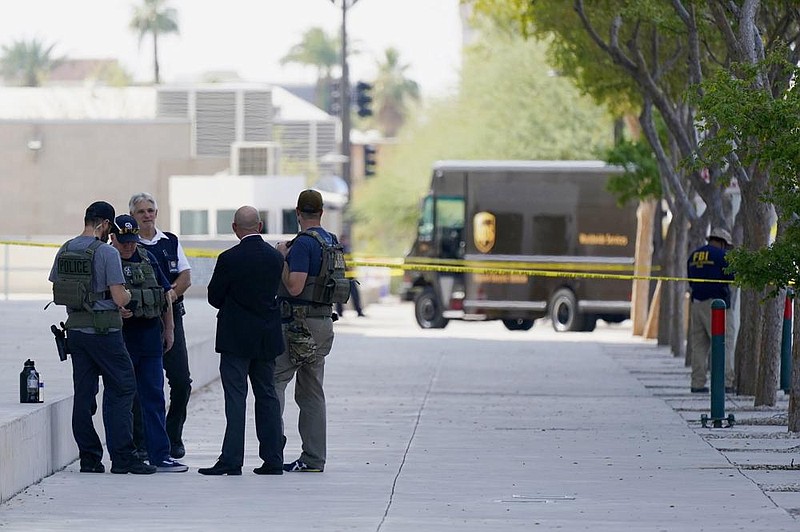 Federal law enforcement personnel work Tuesday outside the Sandra Day O’Connor Federal Courthouse in Phoenix. (AP/Ross D. Franklin) 