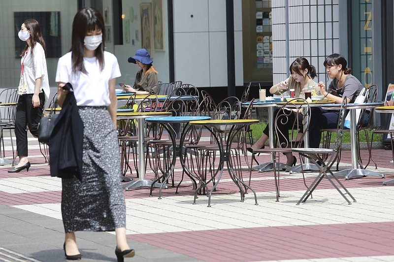 Diners enjoy lunch outside a restaurant Tuesday in Tokyo. (AP/Koji Sasahara) 
