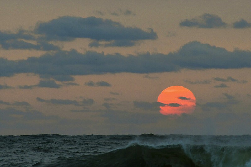 This photo taken at sunrise from Surf City on Long Beach Island in New Jersey shows the sun shrouded in smoke and brown haze Tuesday, Sept. 15, 2020. The smoke from dozens of wildfires in the western United States is stretching clear across the country — and even pushing into Mexico, Canada and Europe. While the dangerous plumes are forcing people inside along the West Coast, residents thousands of miles away in the East are seeing unusually hazy skies and remarkable sunsets. (Elizabeth Laird via AP)

