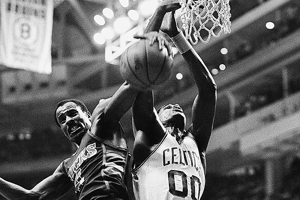 Milwaukee Bucks guard Sidney Moncrief, left, takes the ball away from Boston Celtics Robert Parish during second quarter NBA playoff action at the Boston Garden, May 16, 1984. Boston defeated Milwaukee 119-96 in Game 1 of the series. (AP Photo/Elise Amendola)