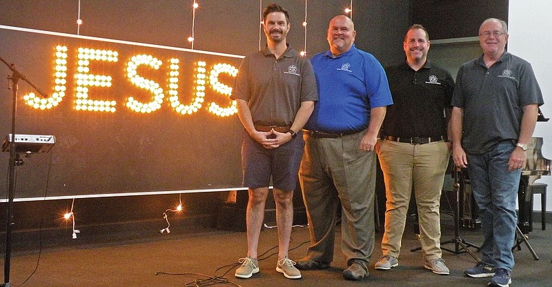 Standing on the stage in the Renewal Ranch Restoration Center are, from left, Bryce McGhee, director of marketing and fundraising; Chase Chism, Phase I supervisor; James Loy, executive director; and Bill Clay, director of spiritual oversight. Renewal Ranch conducts chapel services in the center, as well as other events. Renewal Ranch has received several grants this year to allow for expansion of its drug-and-alcohol rehabilitation program.