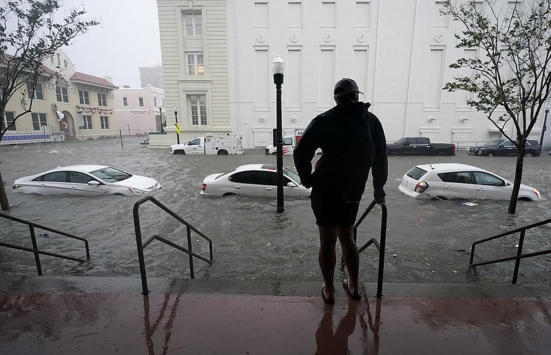 Floodwaters from Hurricane Sally fill the streets Wednesday in Pensacola, Fla., after the slow-moving system made landfall as a Category 2 storm. More photos at arkansasonline.com/917hurricane/.
(AP/Gerald Herbert)