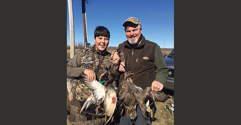 Joe Volpe (right) and his son, John, show off three ducks they bagged near the Arkansas River earlier this year. Hunting has no concrete definition, the author wrote, because its meaning “is personal, spiritual, individualistic.” He also writes that “hunting is a suite of spiritual and sensory intangibles, including the intense gravity of taking a life.”
(Photo submitted by Joe Volpe)